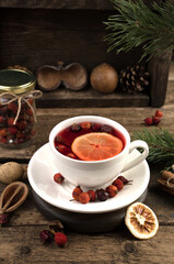 White ceramic tea Cup on a dark wooden background. Side view, vertical orientation. The concept of the new year 2021 and Christmas.