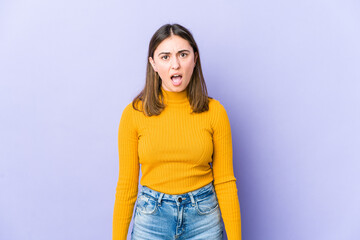 Young caucasian woman shouting very angry, rage concept, frustrated.