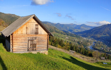 Fototapeta na wymiar Single house on the hill of mountains.