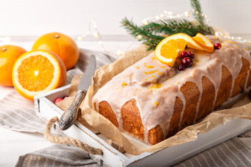 Christmas orange cake with cranberries and sugar icing