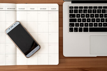 Telework or study space. Blank organizer, laptop and mart phone. Top view.
