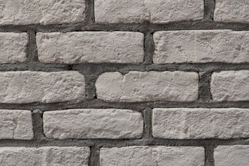 Fragment of a wall with tiles in the form of brickwork. Background. Texture.