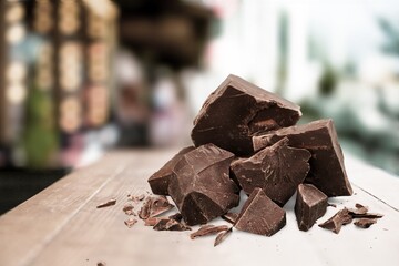 Sweet broken chocolate bar on wooden desk