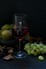wine glass with grapes and fruits on the background