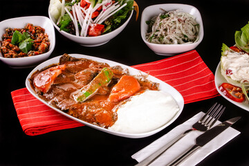 Turkish Traditional İskender Doner Kebab with butter, tomato sauce and yoghurt