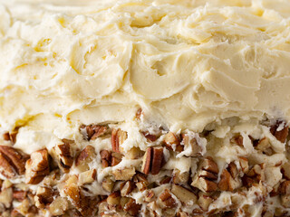 Close up of a southern hummingbird cake showing icing and pecans