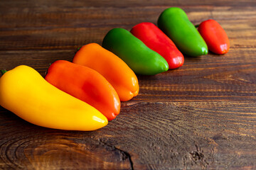 Bulgarian multicolored peppers on a wooden board. Healthy food, vitamins.