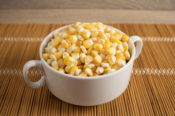 Corn lies on canvas. A new crop. Corn cob on a plate. Sweet corn on background for food ingredients and cooking concept.