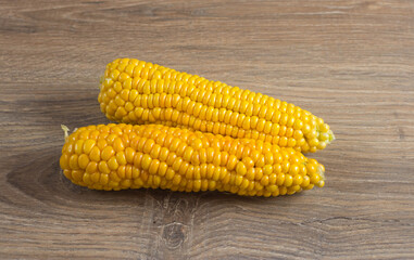 Corn lies on canvas. A new crop. Corn cob on a plate. Sweet corn on background for food ingredients and cooking concept.