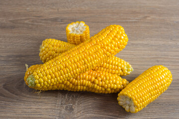 Corn lies on canvas. A new crop. Corn cob on a plate. Sweet corn on background for food ingredients and cooking concept.