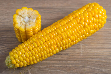 Corn lies on canvas. Fresh corn closeup. Corn cob on a plate. Sweet corn on background for food ingredients and cooking concept.