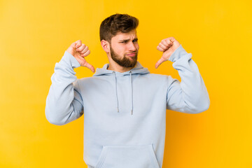 Fototapeta premium Young caucasian man isolated on yellow background feels proud and self confident, example to follow.