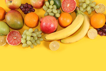 Tropical fruits, grapefruit, orange, lemon on a yellow background, banner. Detox diet minimal concept. Space for text, flat lay. Healthy and natural food concept. Vitamins C,lifestyle