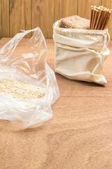 Crispbread in plastic bag. Bread and straws in linen bag.