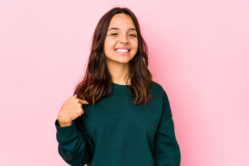 Young mixed race hispanic woman isolated person pointing by hand to a shirt copy space, proud and confident
