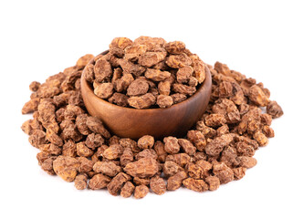 Tigernuts isolated on white background. Chufa nuts or tiger nuts in wooden bowl.