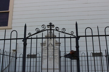Cemetery headstone behind gate