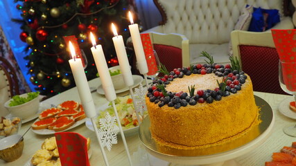 New year's holiday table with candles and snacks