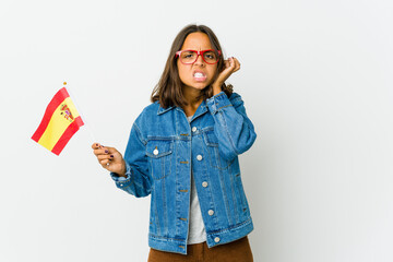 Young spanish woman holding a flag isolated on white background