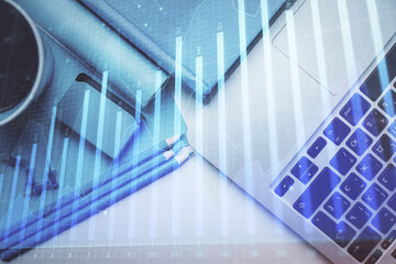 Double exposure of forex graph drawing over desktop background with computer. Concept of financial analysis. Top view.