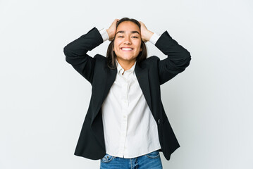 Young asian bussines woman isolated on white background laughs joyfully keeping hands on head. Happiness concept.