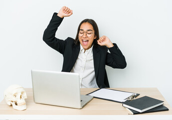 Young traumatologist asian woman isolated on white background celebrating a special day, jumps and raise arms with energy.