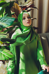 Portrait of a beautiful, elegant and attractive young Malay Asian Muslim woman in a dress and an...