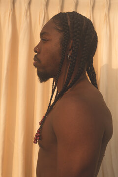 Profile of Black male model with braids