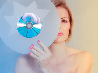 Sound carrier, compact disc, music and a portrait of a young woman