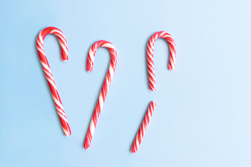 Candy cane on a blue background. Broken candy cane.Christmas concept.