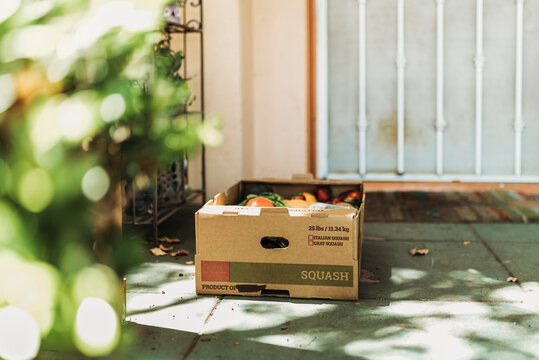 CSA Farmer’s Box Full Of Produce On Front Porch