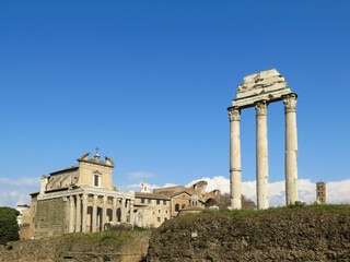 Fototapeta na wymiar Isolated ruins of roman columns with blue sky background from the forum of Roma