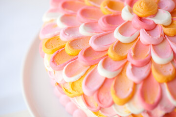 Tri-colored Orange Pink White Frosted Layer Cake on White Plate 