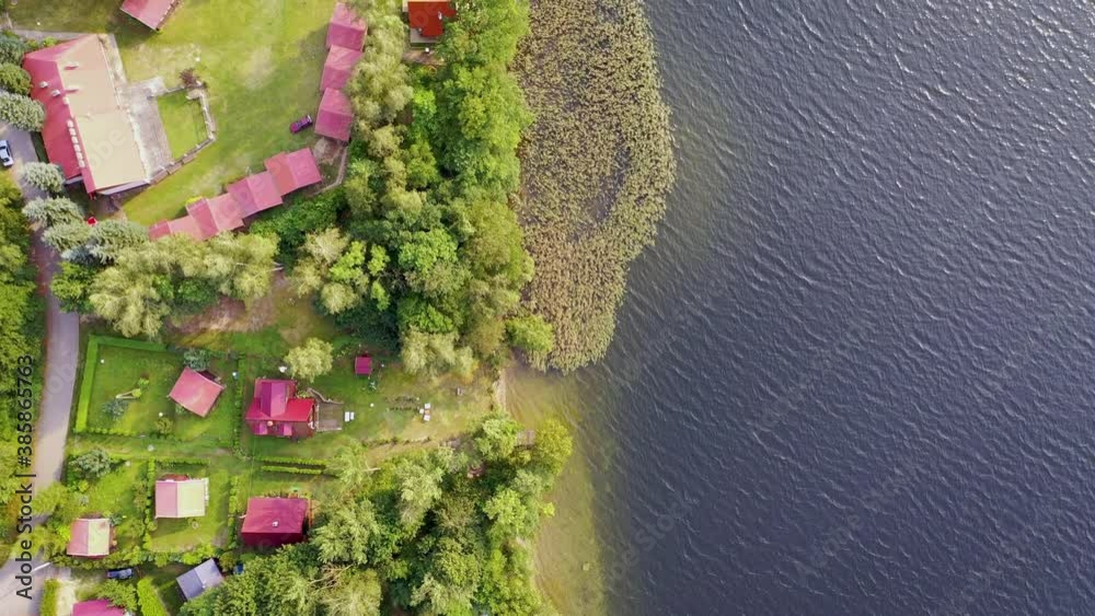 Poster 4K footage of houses over Narie lake in Kretowiny village in Ilawa Lake District, in Warmia Mazury region of Poland