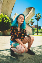Portrait of a blue haired woman with tattoos. Tattoo.