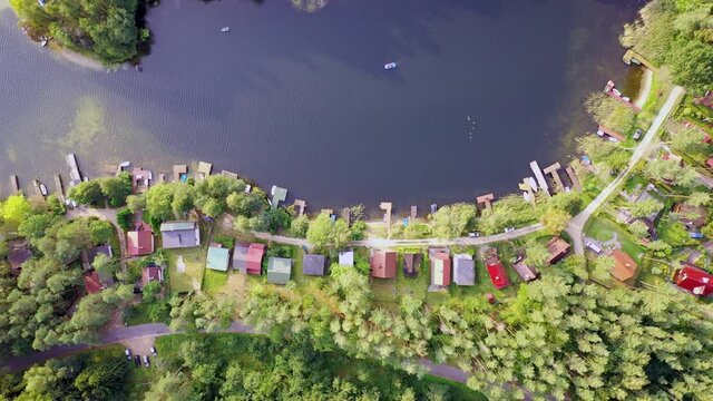 4K footage of summer houses over Narie lake in Kretowiny village, Warmia Mazury region of Poland