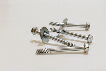 metal screws for threaded fasteners and connections of various parts on white background