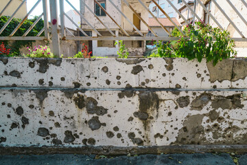 Wall with bullet holes caused by gunshot impacts during the Bosnian War in Mostar, Bosnia and Herzegovina