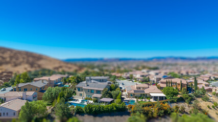 Fototapeta na wymiar Aerial View of Populated Neigborhood Of Houses With Tilt-Shift Blur