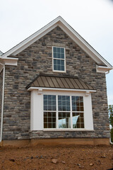 the wall of the house is covered with stones