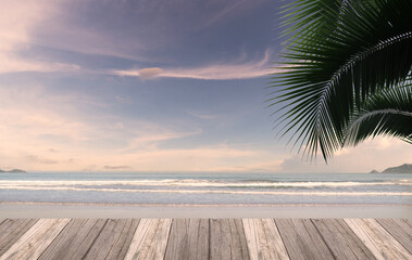 Empty wooden table and palm or coconut leaves with the party on beach background blurred. Concept Summer, Beach, Sea, Relax, Party.