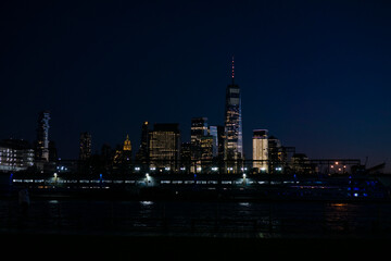 View of skyscrapers along Hudson River in financial district of Manhattan. Skyline of downtown Manhattan at night