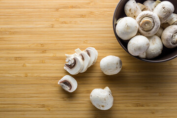 Fresh mushrooms champignon on a wooden board.