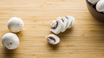 Fresh mushrooms champignon on a wooden board.