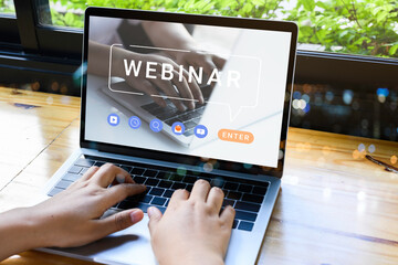 Person using a laptop computer for online training webinars. E-learning browsing connection and cloud online technology webcast concept. Laptop mockup with clipping path on screen