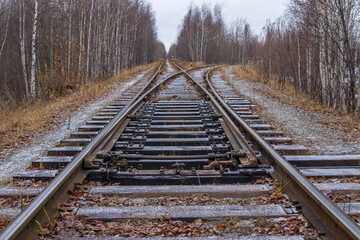Fototapeta premium Old railway in the autumn forest.
