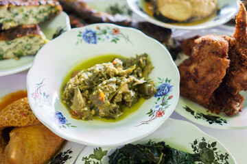 portrait green chilli sauce on a plate on in a traditional food dish