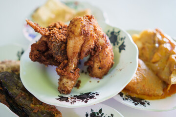 portrait fried chicken food on a plate on in a traditional food dish