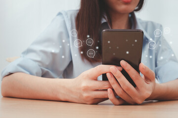 Asian woman using smartphone typing in chat box icons pop up. Social media technology concept.