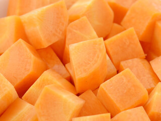 cuts of carrot on wooden background